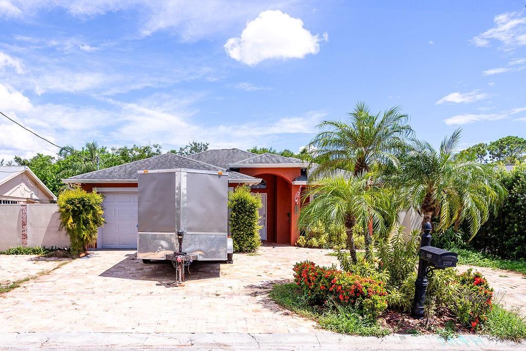 4907 Carlyle Road Tampa, FL 33615 - Photo 4 of 29 a front view of a house with a garden
