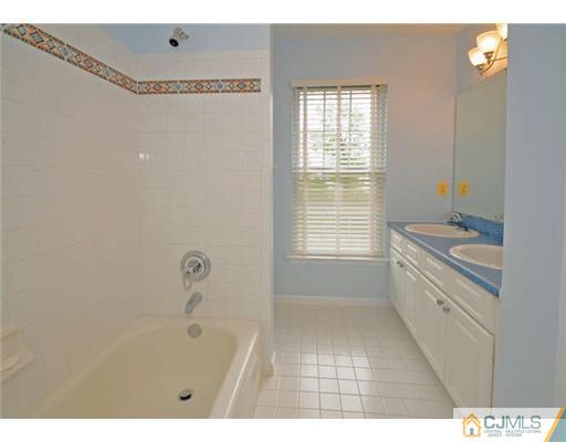 34 Lexington Road Monmouth Junction, NJ 08852 - Photo 14 of 17 a bathroom with a granite countertop sink a toilet and shower