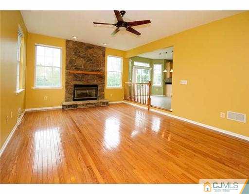 34 Lexington Road Monmouth Junction, NJ 08852 - Photo 6 of 17 a view of empty room with a fireplace and wooden floor