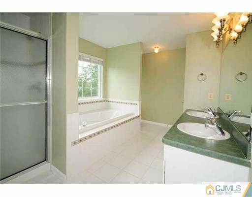 34 Lexington Road Monmouth Junction, NJ 08852 - Photo 10 of 17 a bathroom with a granite countertop sink a bathtub and a mirror