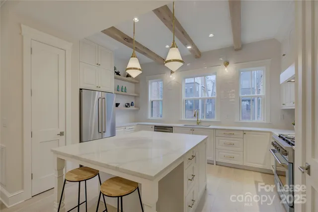 a kitchen with a table chairs refrigerator and cabinets