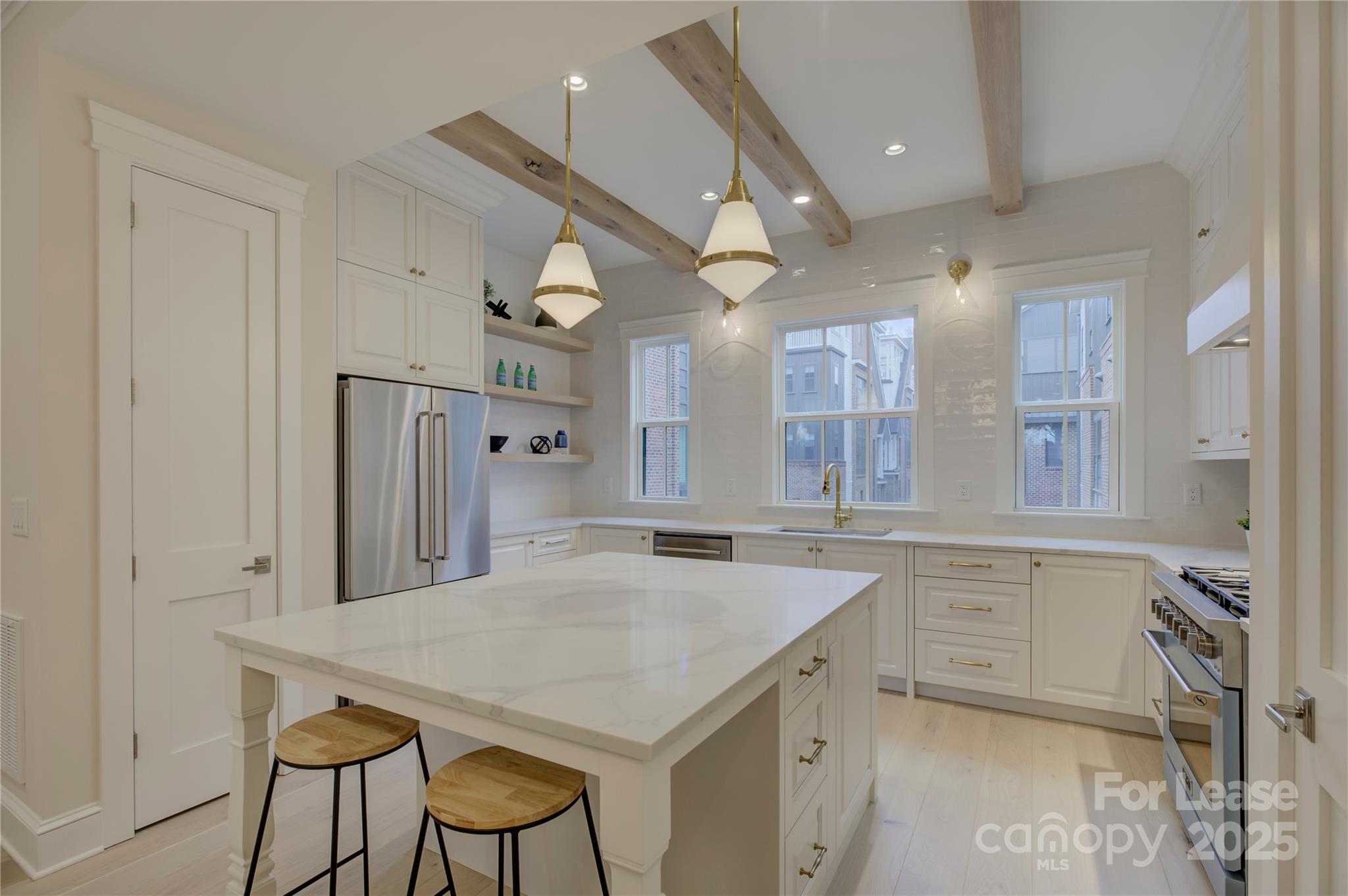 3015 Pinehurst Place Charlotte, NC 28209 - Photo 1 of 31 a kitchen with a table chairs refrigerator and cabinets