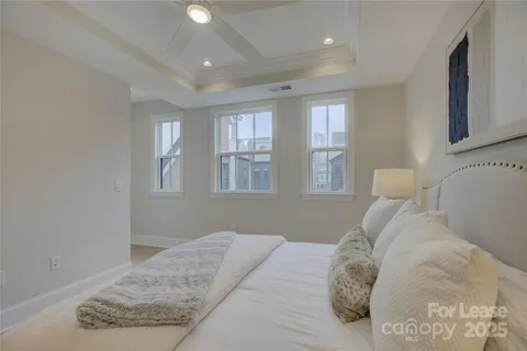 a bedroom with a bed and a potted plant