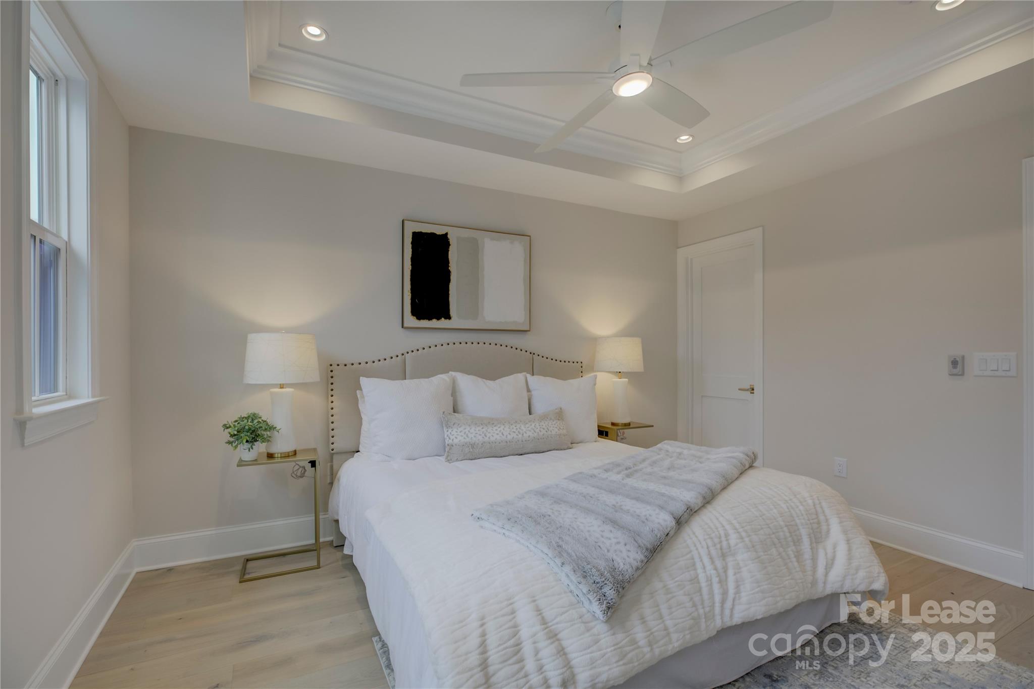 3015 Pinehurst Place Charlotte, NC 28209 - Photo 16 of 31 a bedroom with a bed and a potted plant