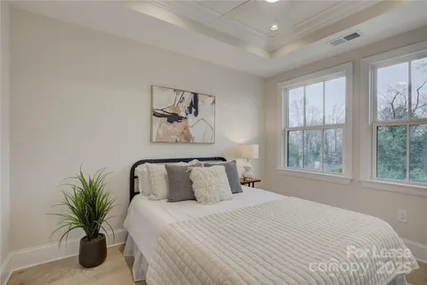 a bedroom with a bed and painting on the wall