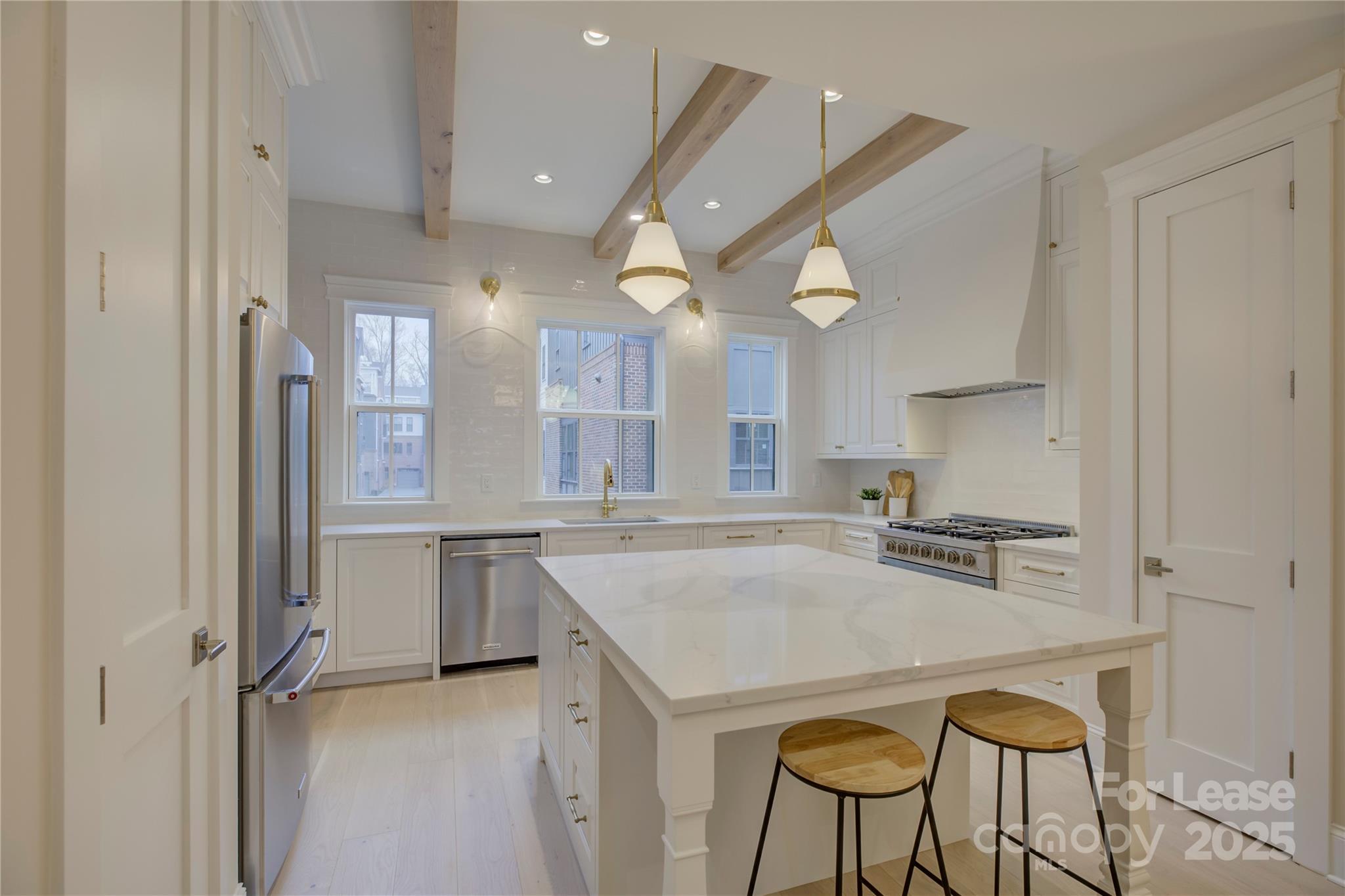 3015 Pinehurst Place Charlotte, NC 28209 - Photo 7 of 31 a kitchen with stainless steel appliances granite countertop a stove a sink and a refrigerator