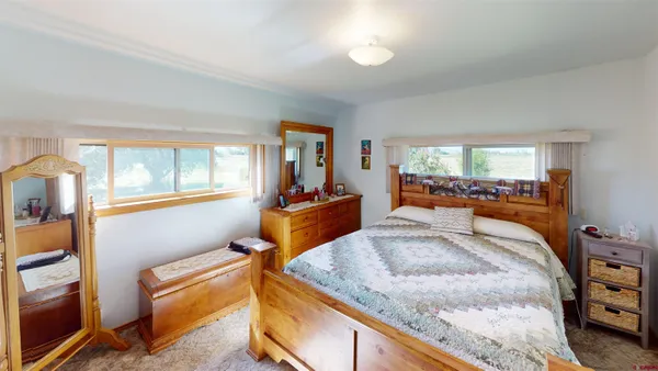 a bedroom with granite countertop sink and natural light