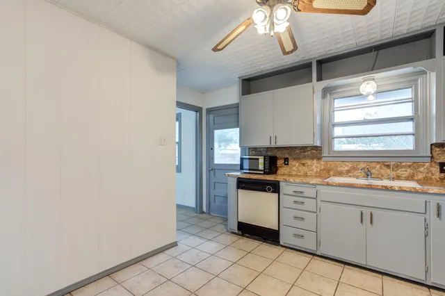 a kitchen with white cabinets and white appliances