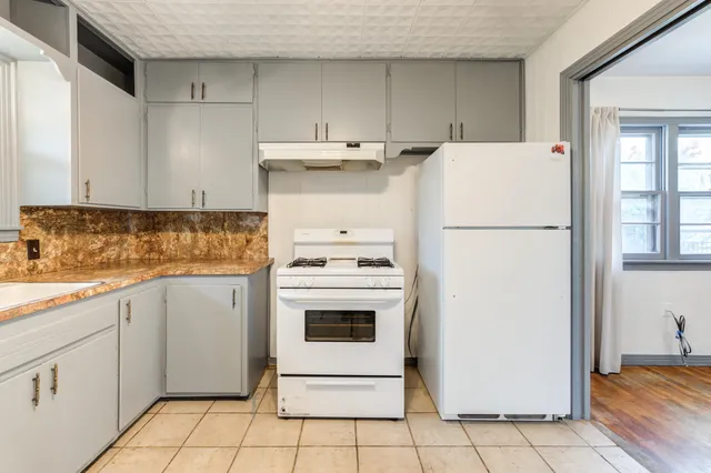 a utility room with cabinets washer and dryer