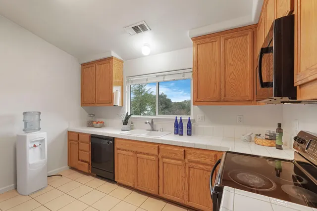 a kitchen with a sink stove and cabinets