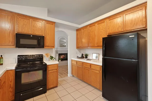 a kitchen with a refrigerator stove and microwave