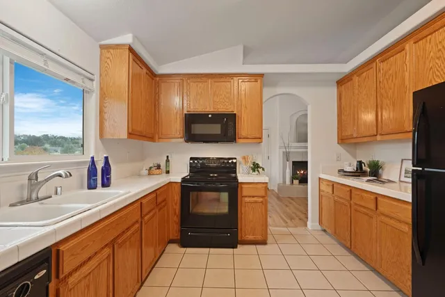a kitchen with stainless steel appliances granite countertop a stove sink and cabinets