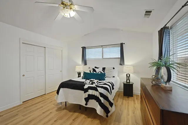 a bedroom with a bed and a chandelier