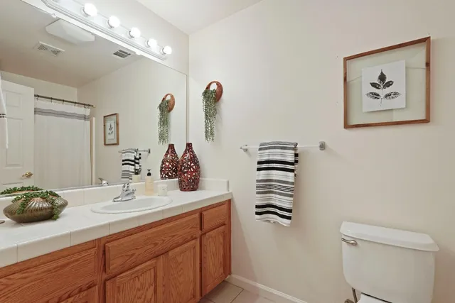 a bathroom with a sink a toilet and mirror