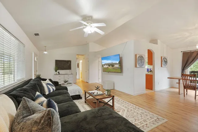 a living room with furniture and a flat screen tv