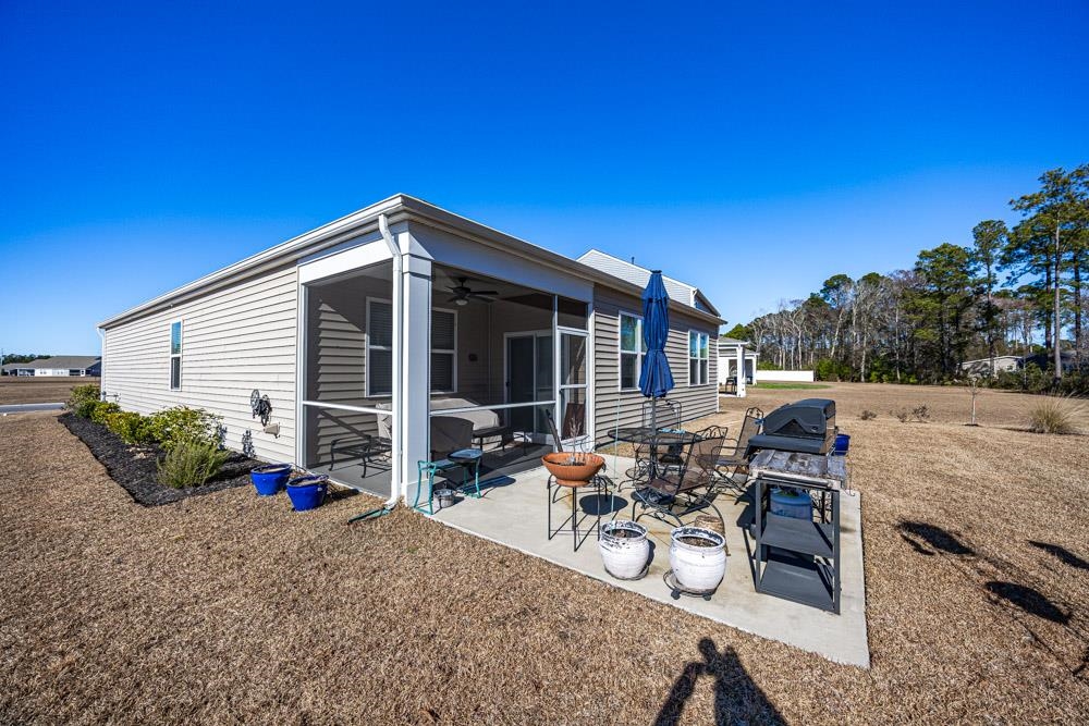 2115 Ridgedale Drive Conway, SC 29526 - Photo 24 of 38 Back of house with a sunroom, a ceiling fan, and a patio