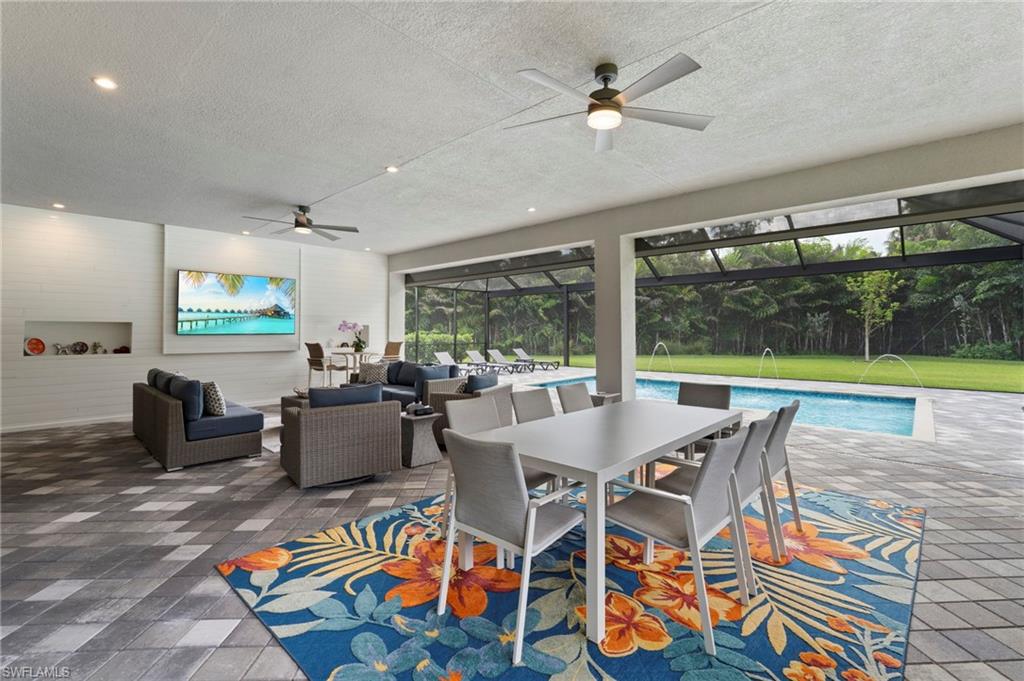 12083 Azalea Way Naples, FL 34120 - Photo 13 of 48 Feature wall with ship lap adds to the appeal of the outdoor living space.