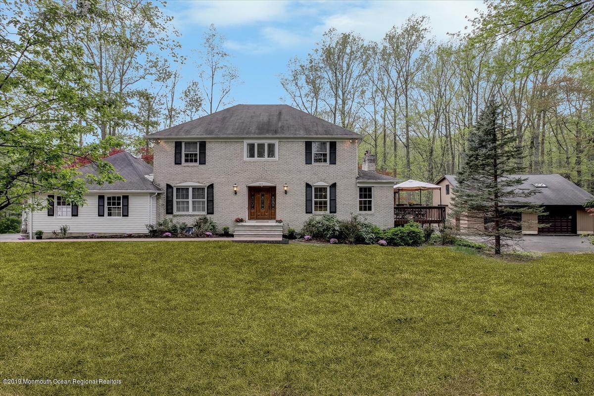 111 Reids Hill Road Morganville, NJ 07751 - Photo 1 of 39 a view of a house with backyard and trees