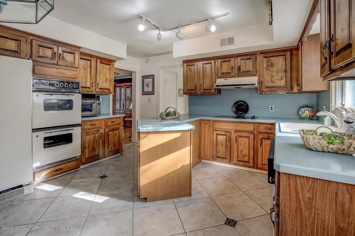 111 Reids Hill Road Morganville, NJ 07751 - Photo 12 of 39 a kitchen with stainless steel appliances and a kitchen