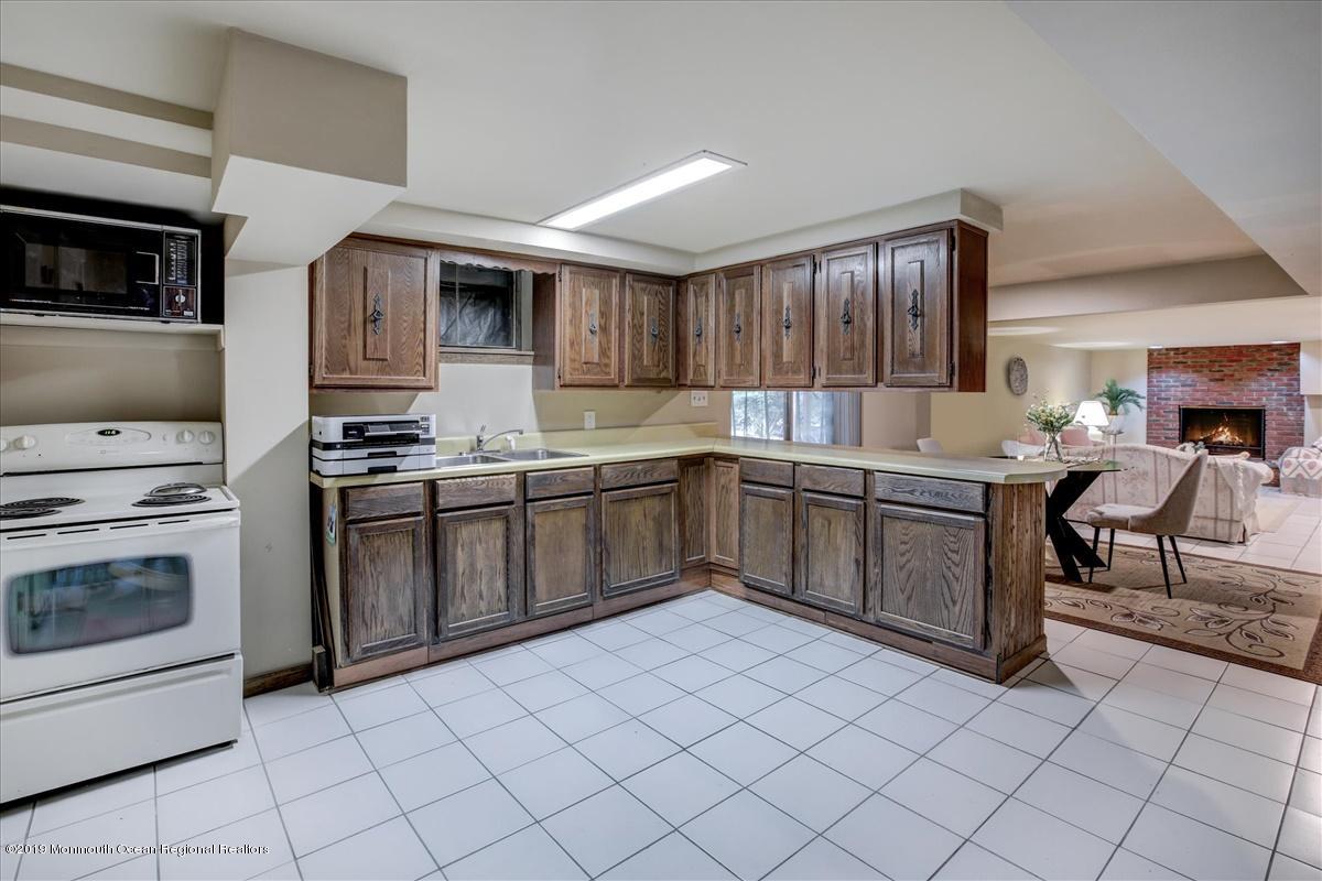 111 Reids Hill Road Morganville, NJ 07751 - Photo 23 of 39 a kitchen with a stove sink and cabinets