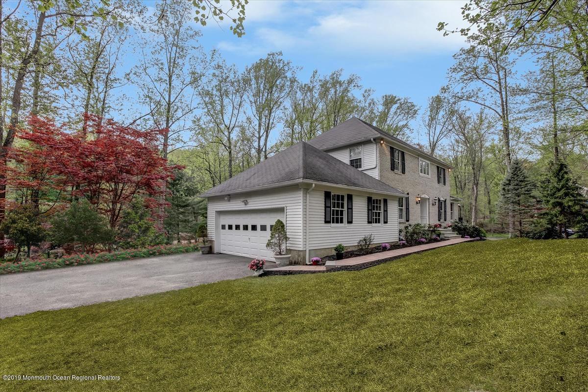 111 Reids Hill Road Morganville, NJ 07751 - Photo 3 of 39 a front view of a house with garden