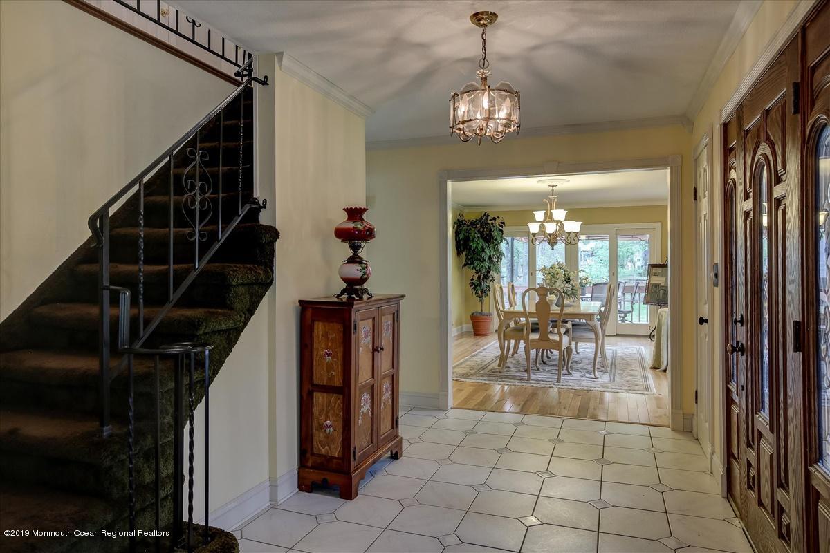 111 Reids Hill Road Morganville, NJ 07751 - Photo 6 of 39 a view of a dining room with furniture and chandelier