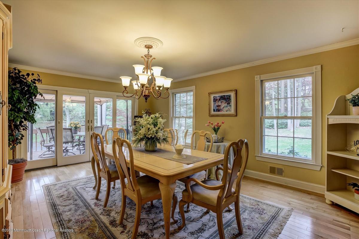 111 Reids Hill Road Morganville, NJ 07751 - Photo 8 of 39 a view of a dining room with furniture a chandelier and wooden floor