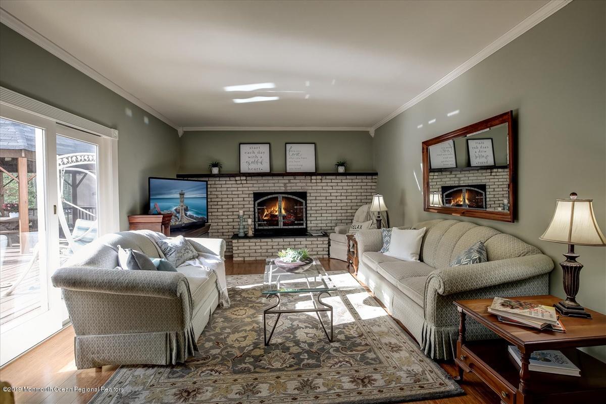 111 Reids Hill Road Morganville, NJ 07751 - Photo 9 of 39 a living room with furniture and a fireplace