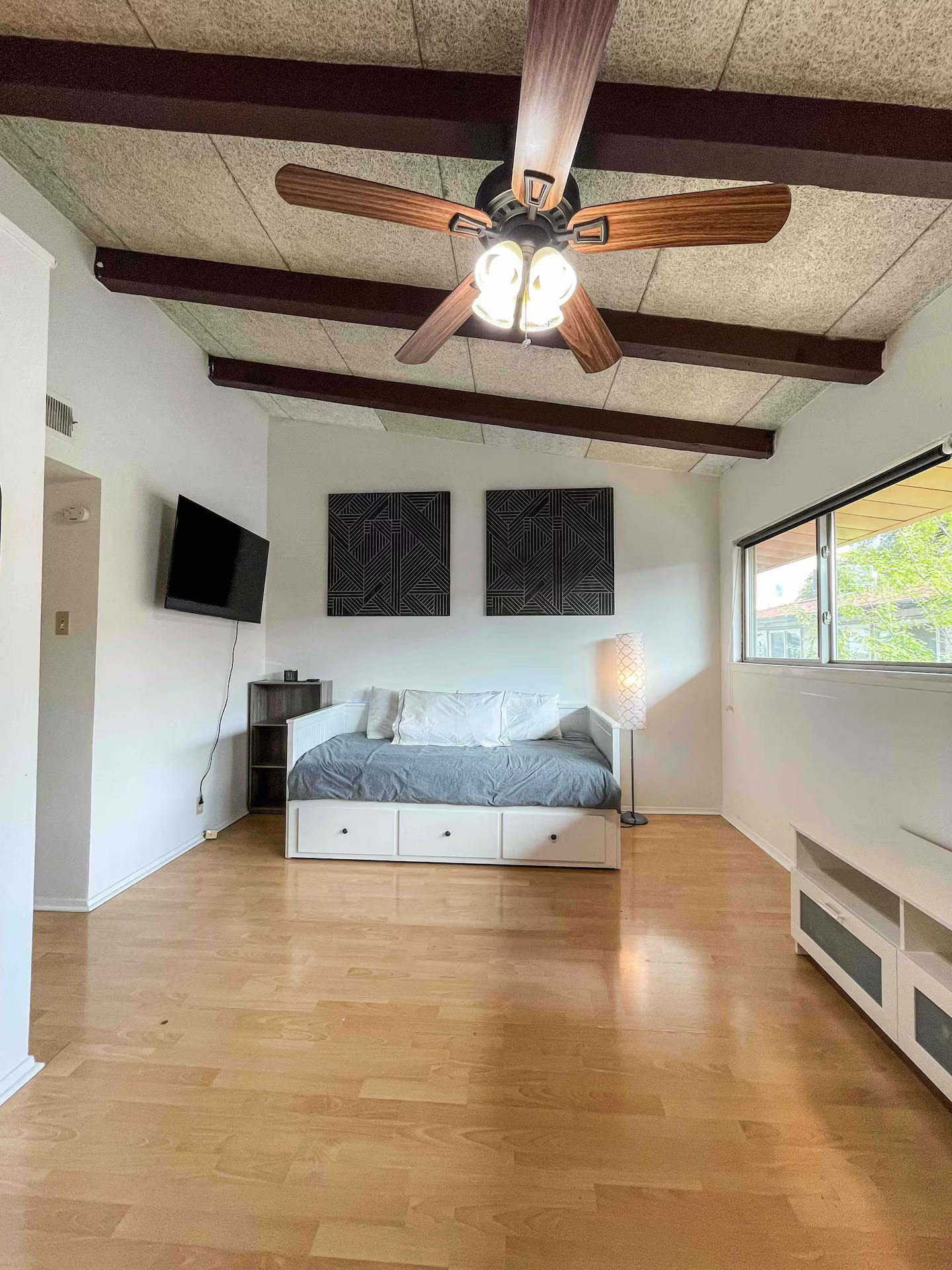 2404 Longview Street, Unit 204 Austin, TX 78705 - Photo 3 of 9 Bedroom featuring light wood finished floors, ceiling fan, and vaulted ceiling with beams