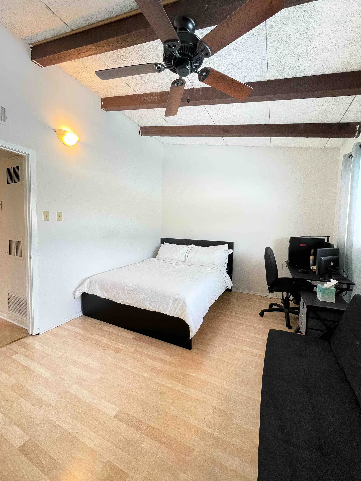 2404 Longview Street, Unit 204 Austin, TX 78705 - Photo 7 of 9 Bedroom with a desk, a ceiling fan, beam ceiling, and light wood finished floors