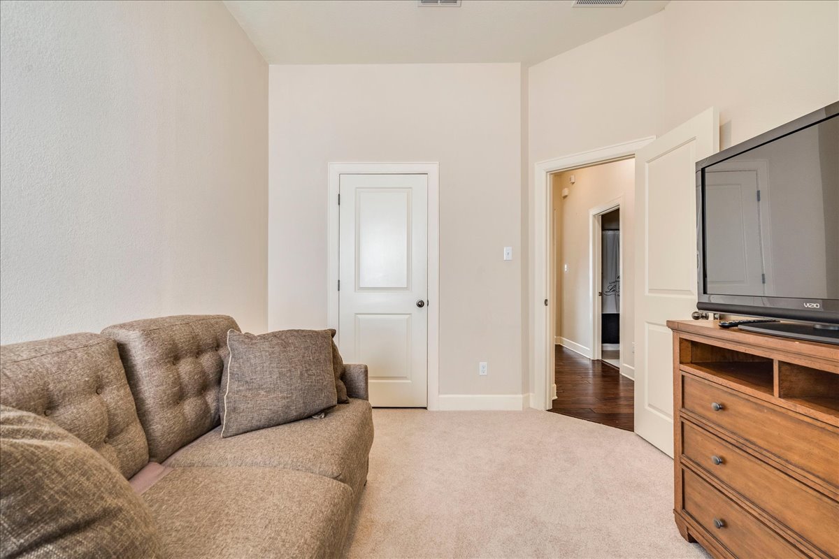 12909 Medina River Way Austin, TX 78732 - Photo 26 of 36 High ceilings and neutral carpet define this versatile secondary bedroom.