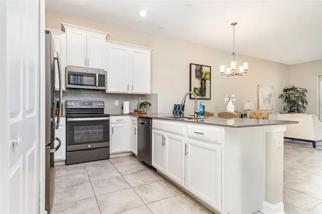 a kitchen with a sink stove and microwave