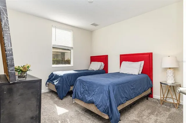 a bedroom with a bed and windows