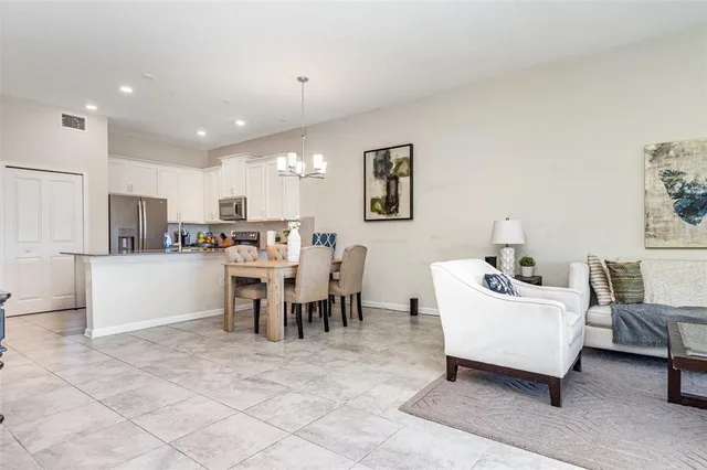 a living room with furniture a dining table and kitchen view