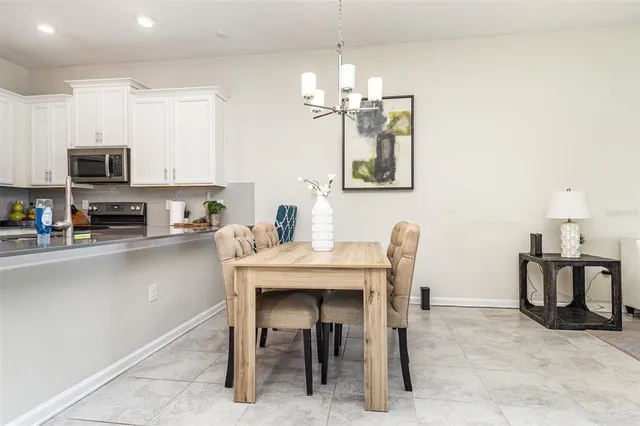 a dining room with furniture and chandelier