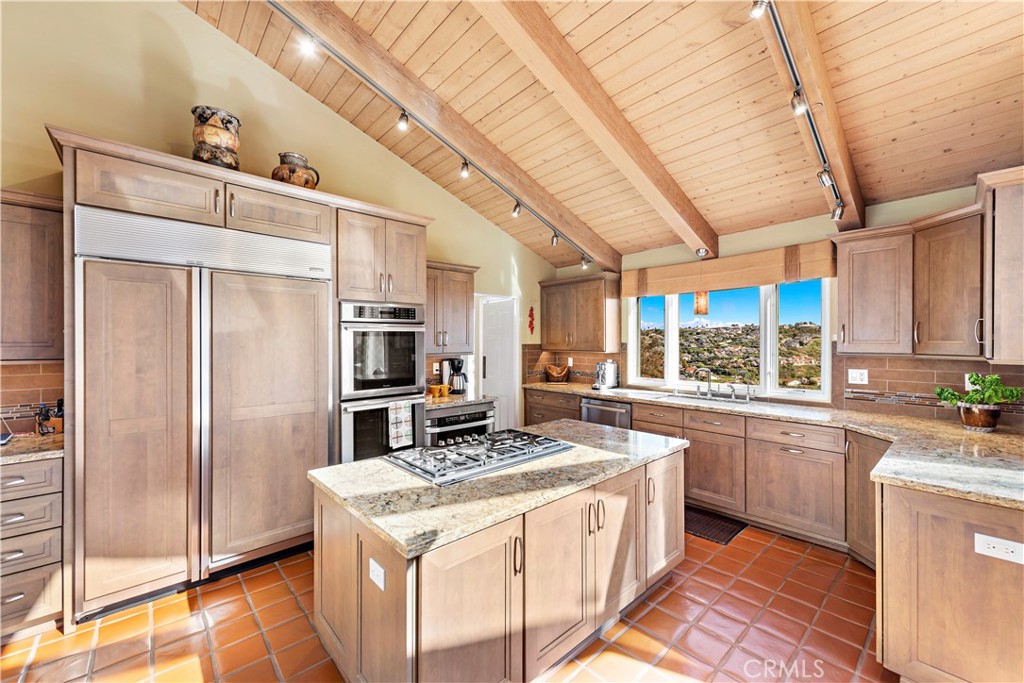 6 Marana San Clemente, CA 92673 - Photo 23 of 69 a kitchen with stainless steel appliances granite countertop a stove a refrigerator a sink dishwasher and wooden cabinets with wooden floor