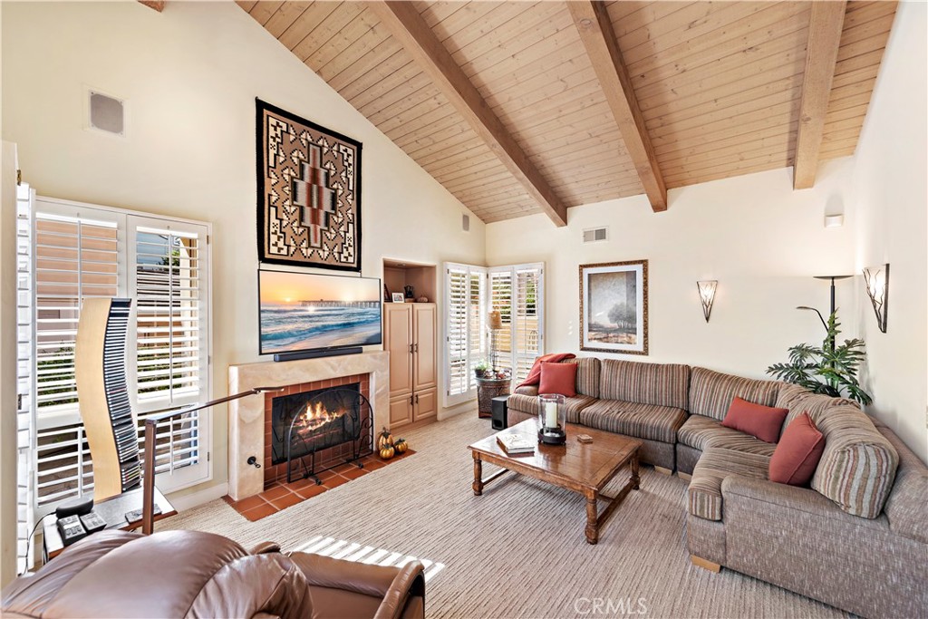 6 Marana San Clemente, CA 92673 - Photo 27 of 69 a living room with furniture a fireplace and a flat screen tv