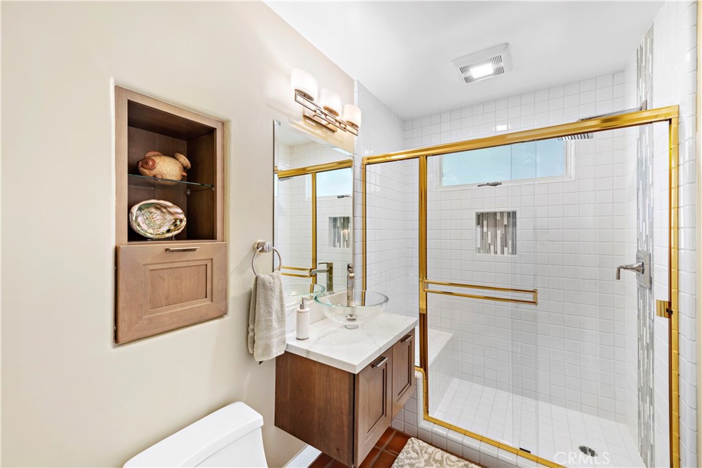 6 Marana San Clemente, CA 92673 - Photo 31 of 69 a bathroom with a sink a mirror and a shower