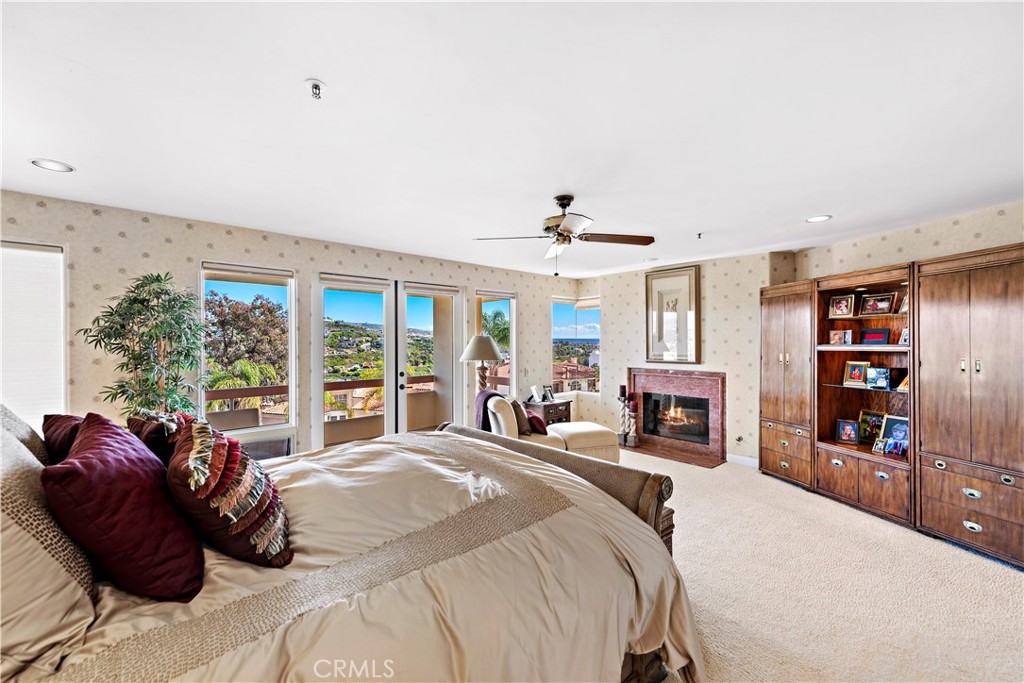 6 Marana San Clemente, CA 92673 - Photo 42 of 69 a large bedroom with a bed a flat tv screen and a large window with the outer view