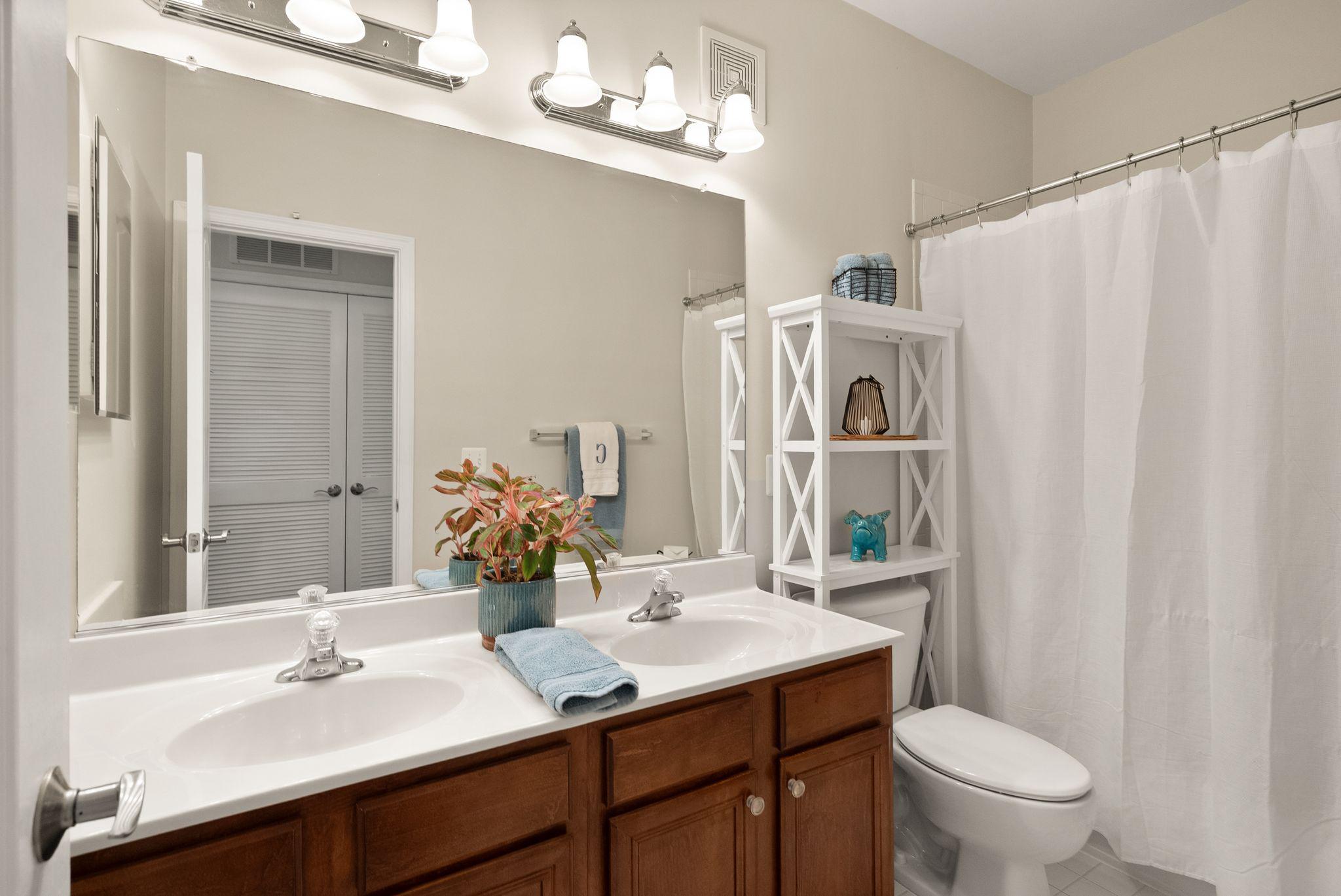 12414 A Liberty Bridge Road Fairfax, VA 22033 - Photo 29 of 38 a bathroom with a sink vanity mirror and toilet