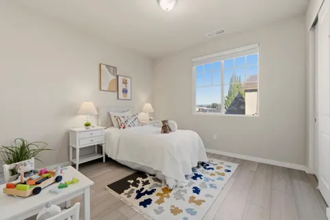 a bedroom with bed and a window