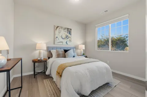 a bedroom with a bed and wooden floor