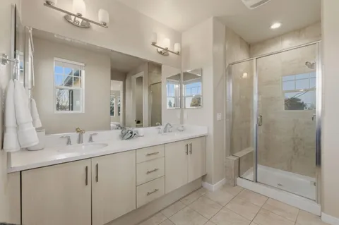 a bathroom with a shower sink and mirror
