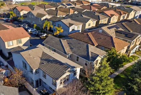 an aerial view of a house with a yard