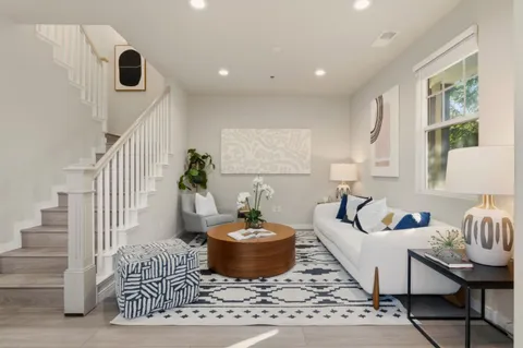a living room with furniture and a potted plant