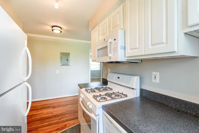 a kitchen with granite countertop a stove and a sink