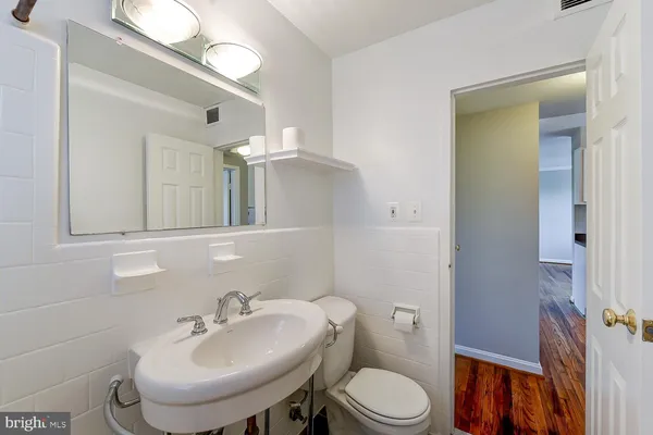 a bathroom with a sink toilet and mirror