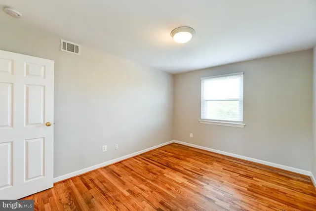 a view of a room with wooden floor and fan