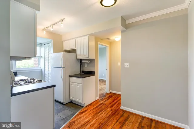 a kitchen with stainless steel appliances a refrigerator and a stove top oven