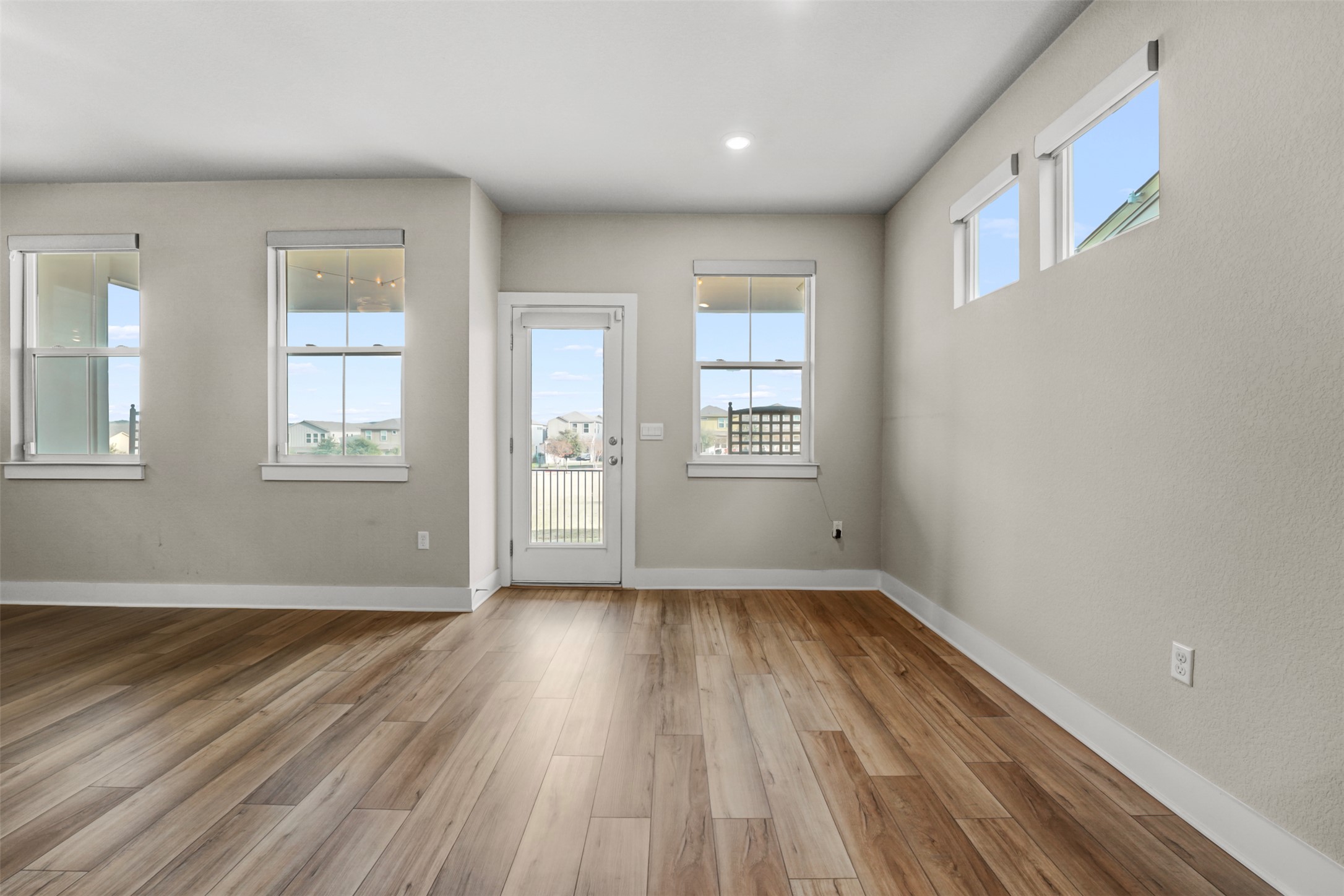 7509 Grand Linden Way, Unit 87 Austin, TX 78744 - Photo 10 of 30 a view of an empty room with wooden floor and windows
